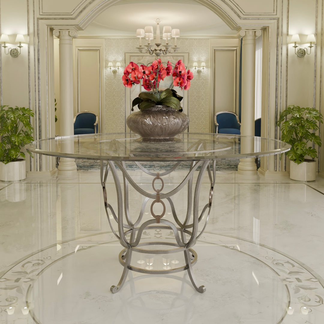 Hala forged metal entrance table with glass top and sculptural silhouette.