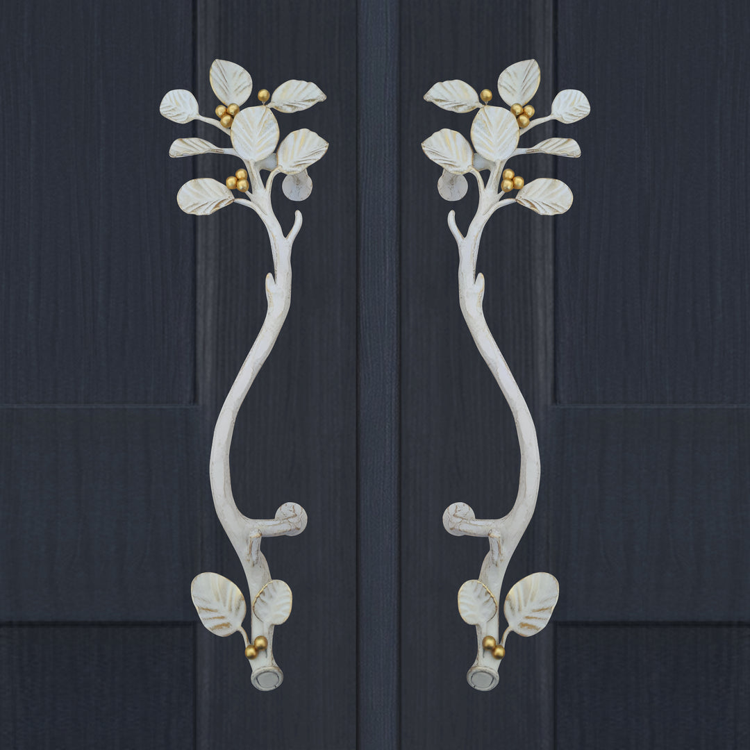 Alba door handles in antique white with sculpted leaves and gold berry detail by Choufani