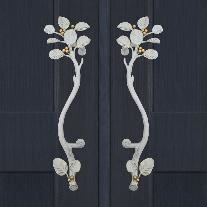 Alba door handles in antique white with sculpted leaves and gold berry detail by Choufani