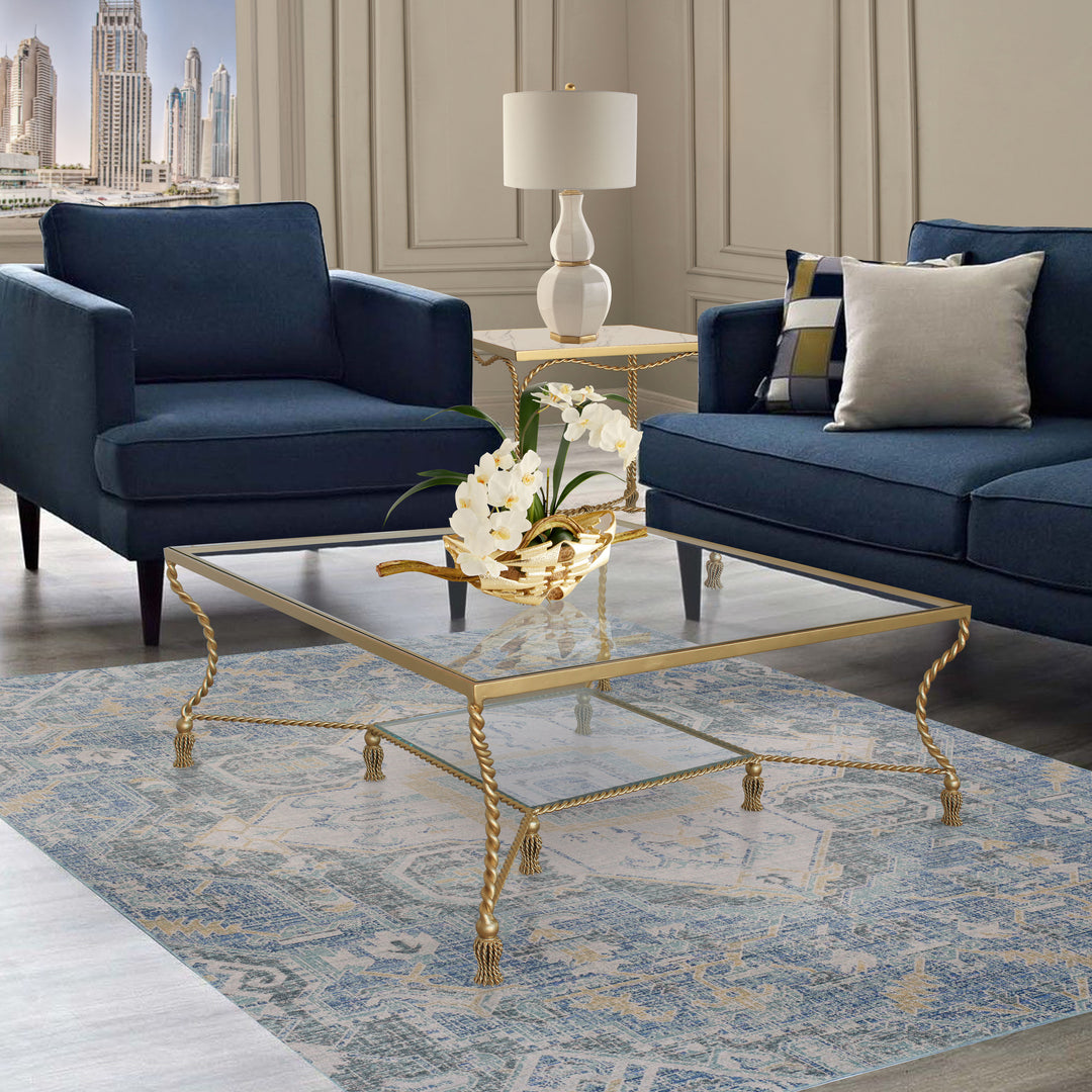 Allegra square gold 2-layered center table with twisted legs and tassel detail.