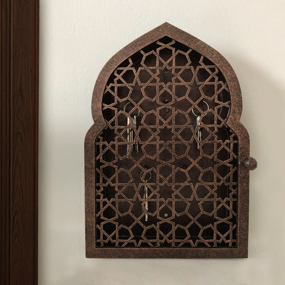 A wall mounted bronze decorative key cabinet with an Islamic design pattern