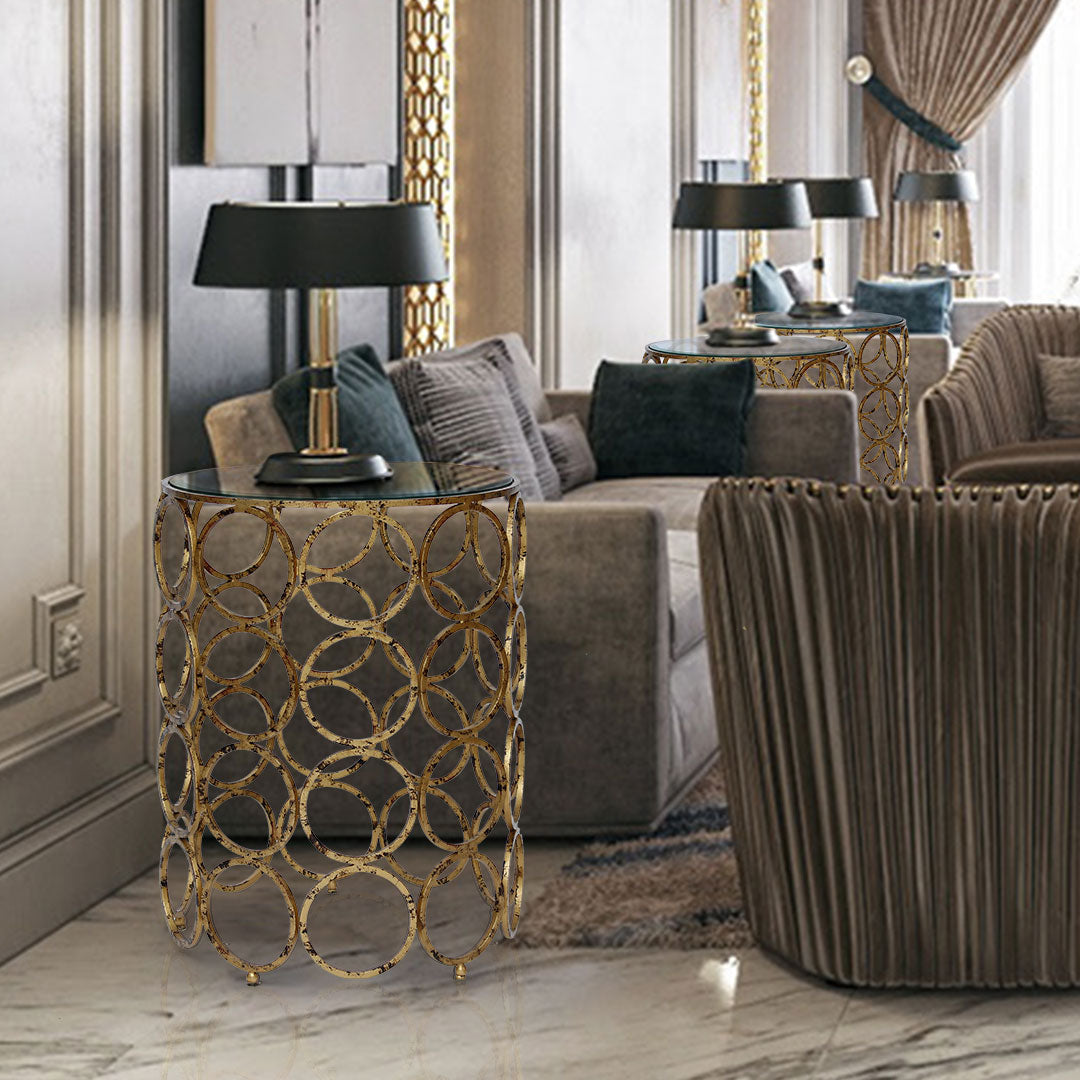 Cielo side table with circular gold metal base and clear glass top