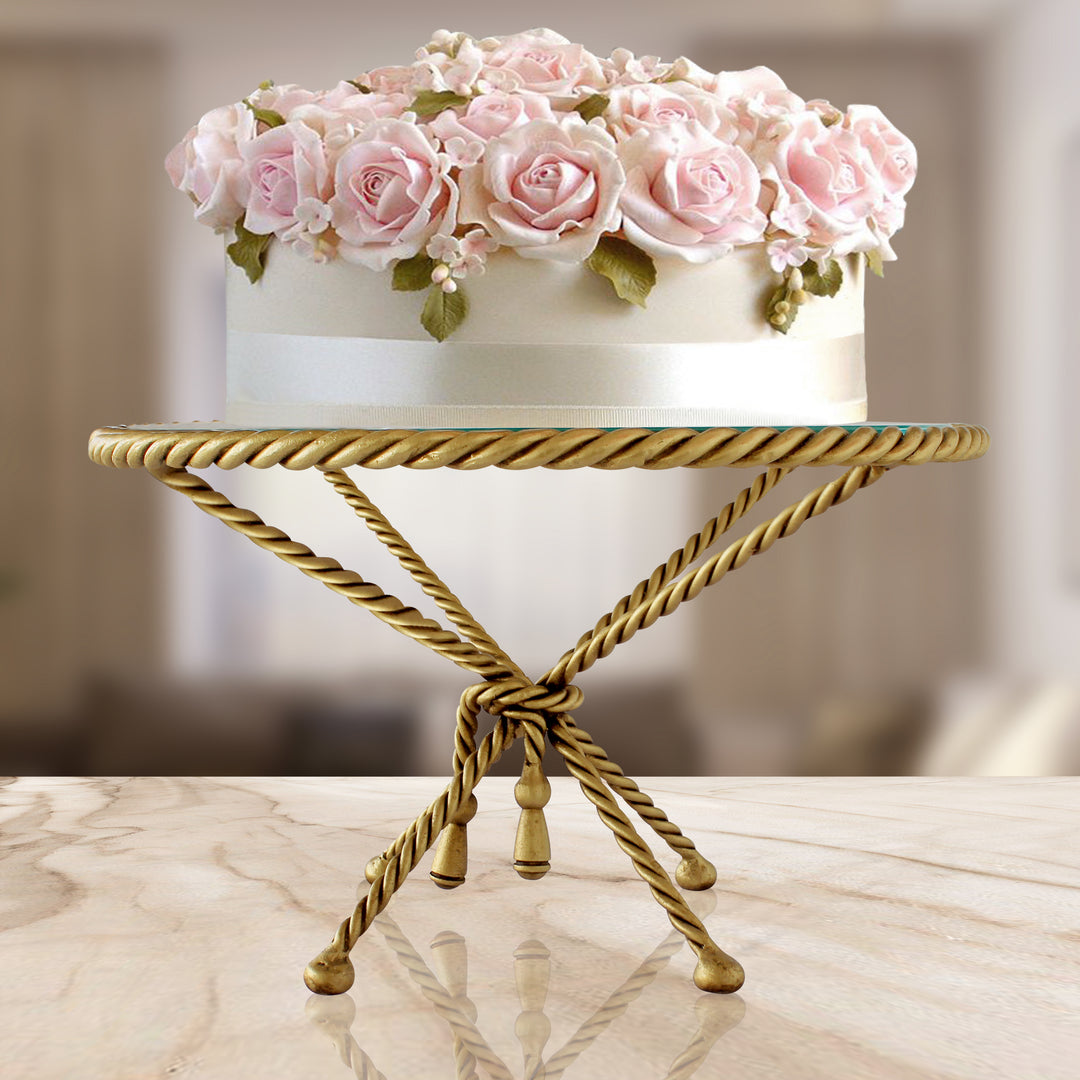 Cordelia sculptural cake stand with twisted gold base and glass top.