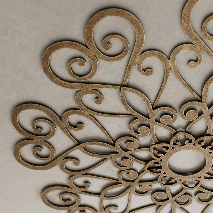 Close up of a decorative metallic ceiling medallion with a bronze painted finish