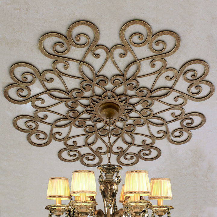 Cupido ceiling medallion with antique gold scroll pattern above chandelier