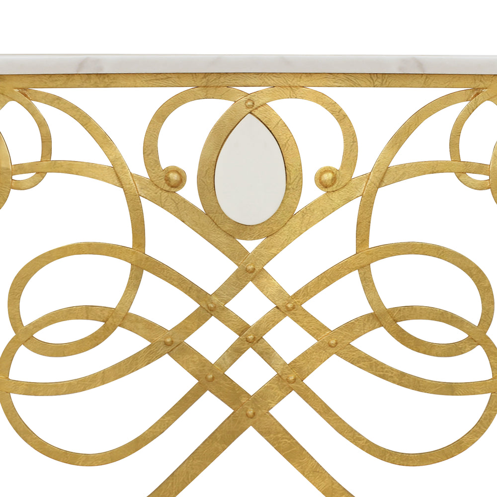 Close up of a unique wrought iron entrance table with gold leaf finish, topped with white natural marble