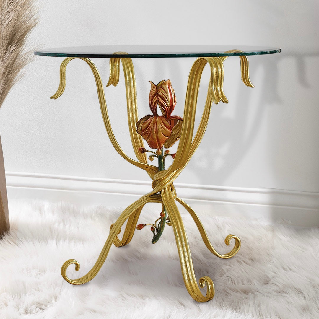 Jolie side table with sculpted floral centerpiece in forged metal and round glass top.