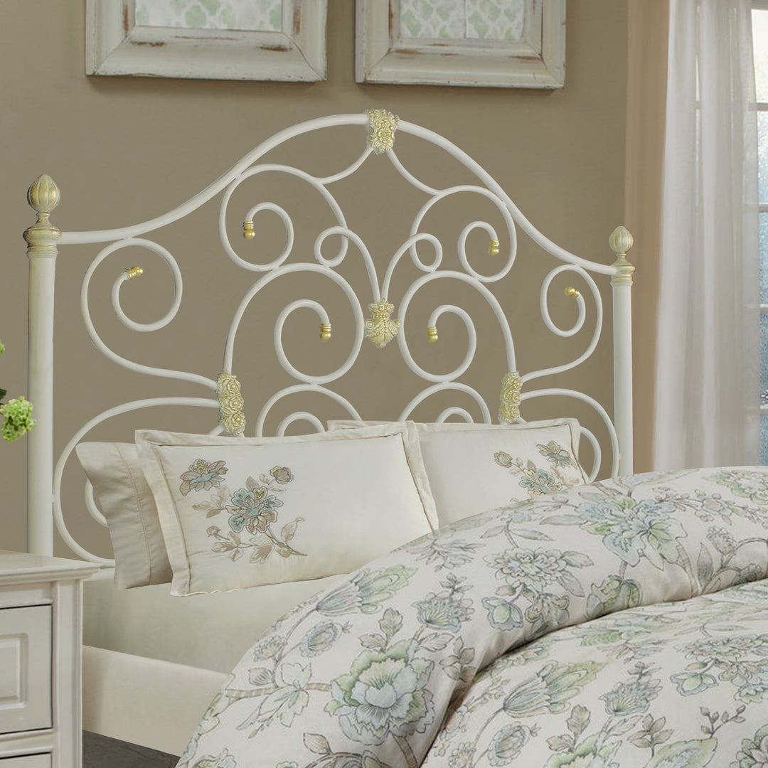 Kate bed with scrollwork iron headboard and ornamental gold accents by Choufani