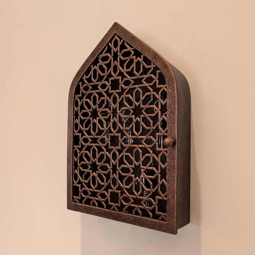 Decorative wall-mounted key box with ornate openwork lattice design and antique finish