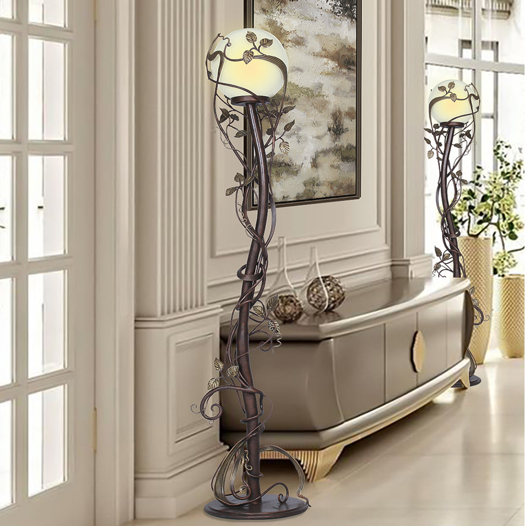 Two luxurious wrought iron decorative floor lamps made up of stems and leaves, stand in a luxurious living space