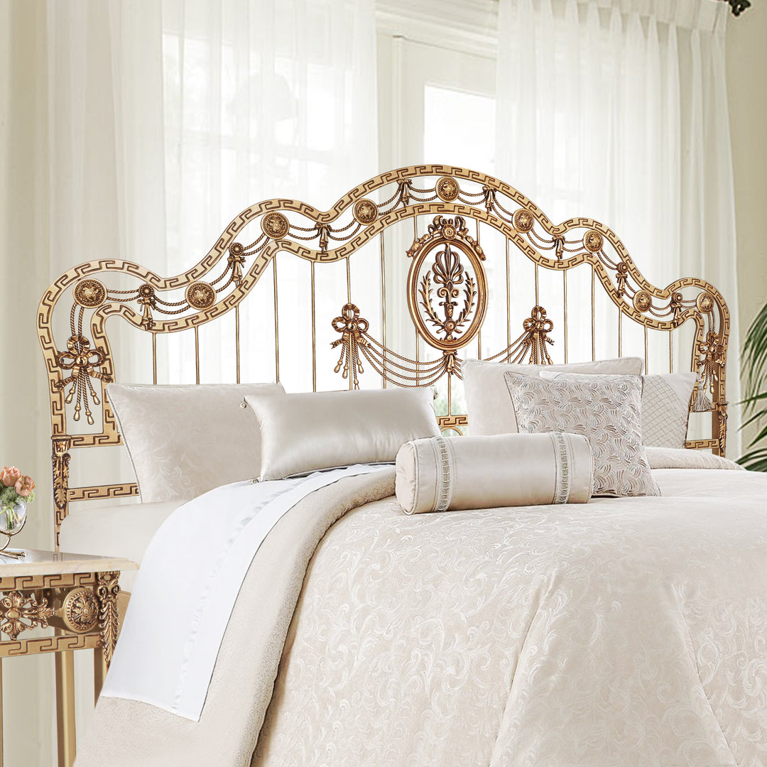 Ornate wrought iron bed with classical medallions and ribbon motifs in a regal finish