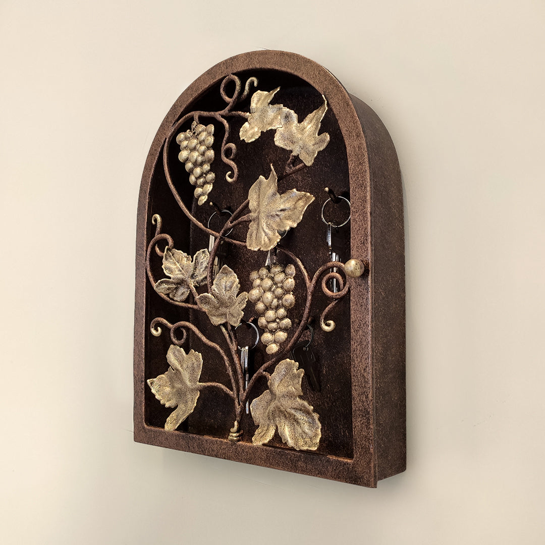 Decorative wall-mounted key box with grapevine leaf and fruit design in antique finish