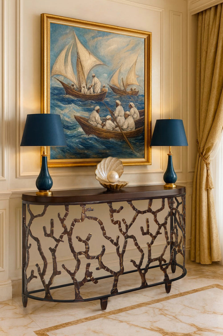 Verona console table by Choufani, featuring handcrafted branch-inspired wrought-iron legs and a rich wooden top, styled in an elegant classical interior with blue lamps, gold accents, and a maritime painting in the background.
