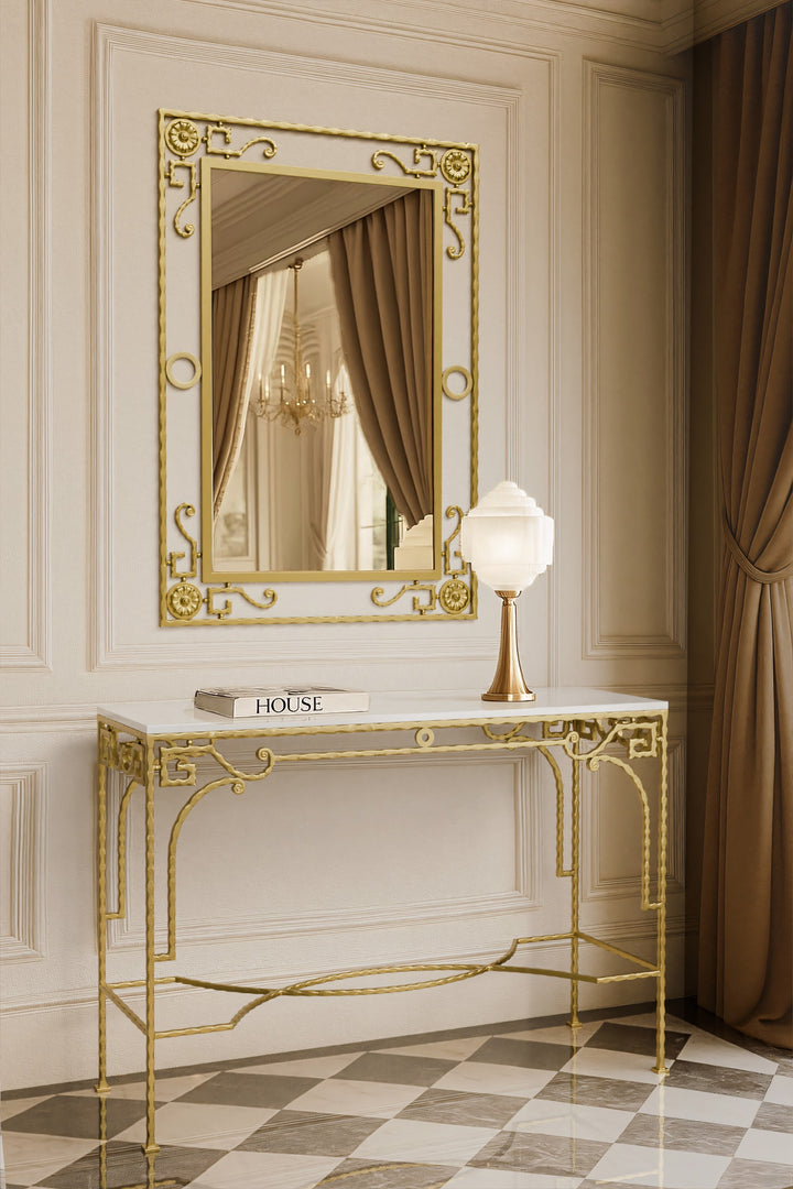 Decorative iron console table with gold frame and mirror in an elegant room.