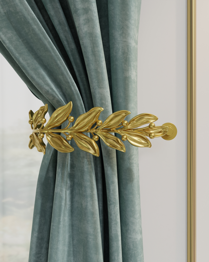 Gold curtain holdback with leaves and buds holding a velvet curtain in place