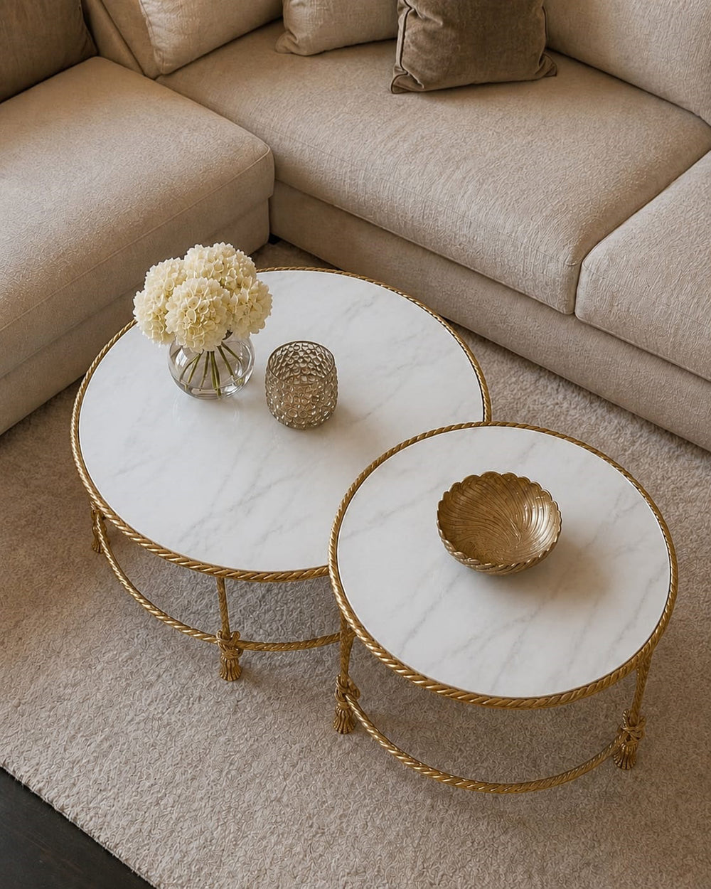 Top view of Allegra nesting tables with natural white marble tops, handcrafted gold rope-inspired frames, and elegant decorative details.