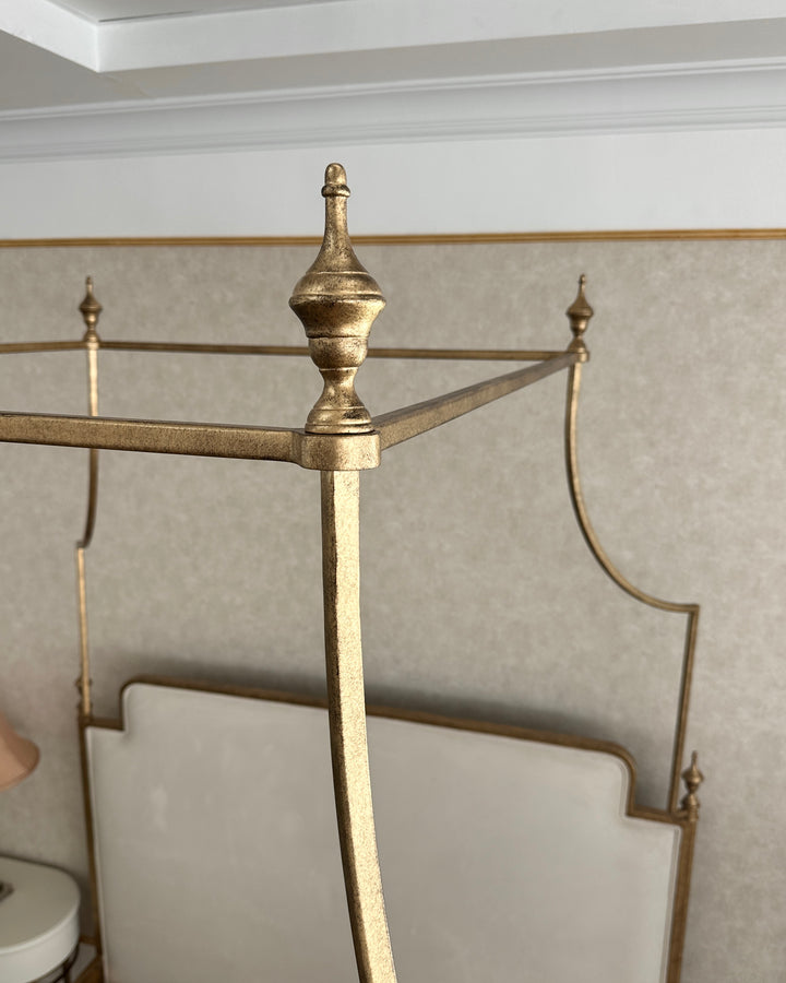 Close-up of Ella canopy bed upholstered headboard and refined metal detailing