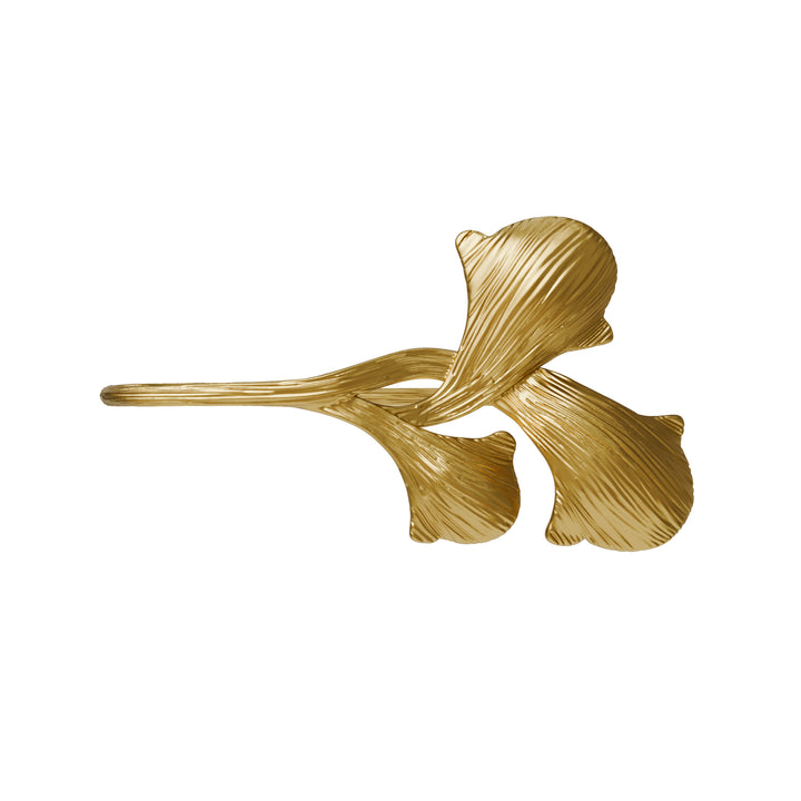 Gold leaf-shaped object on a white background right side