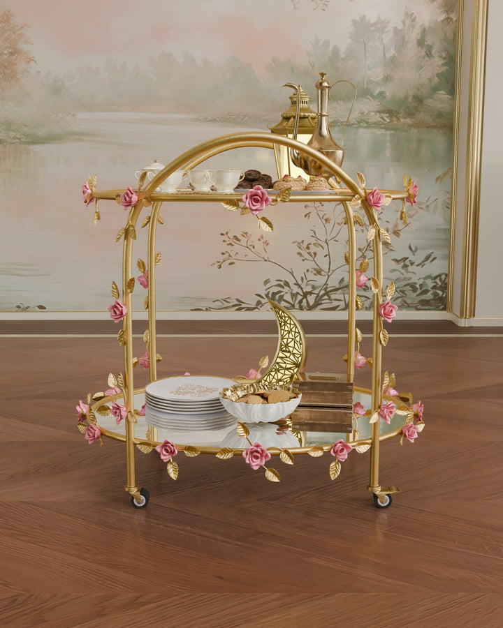 Front view of Rosetta rose serving trolley in gold wrought iron with pink floral accents and glass and mirror shelves