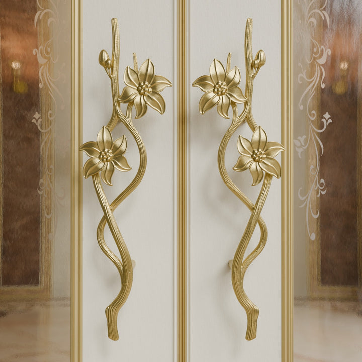 Jasmine door handles in gold finish with floral and vine-inspired sculpted design on luxury double doors