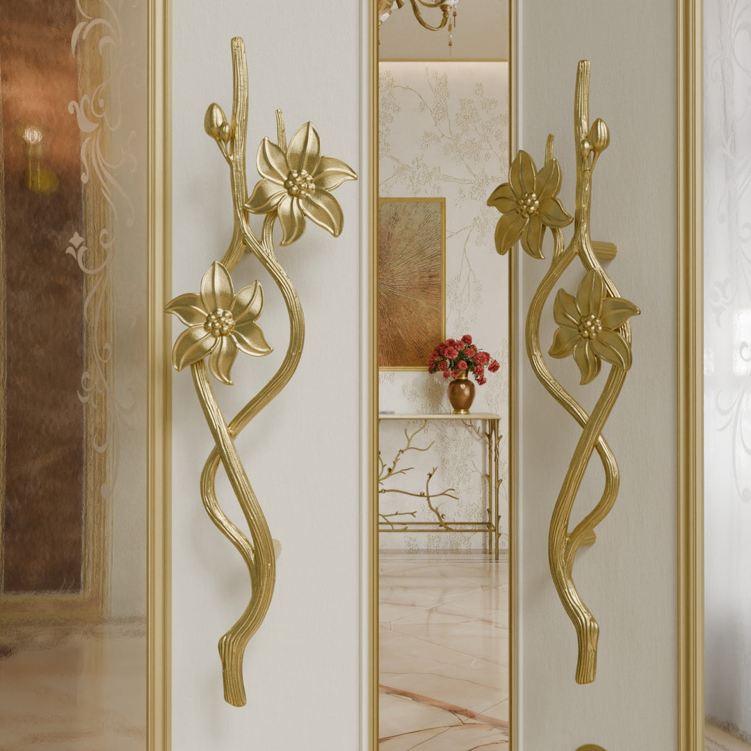 Jasmine door handles in gold finish with floral and vine-inspired design on open luxury door