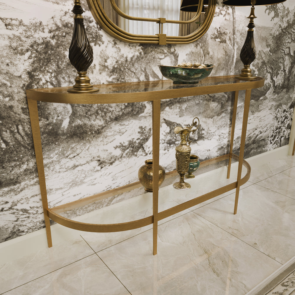 Elegant gold console styled with dark lamps, ceramics, and a scenic mural backdrop