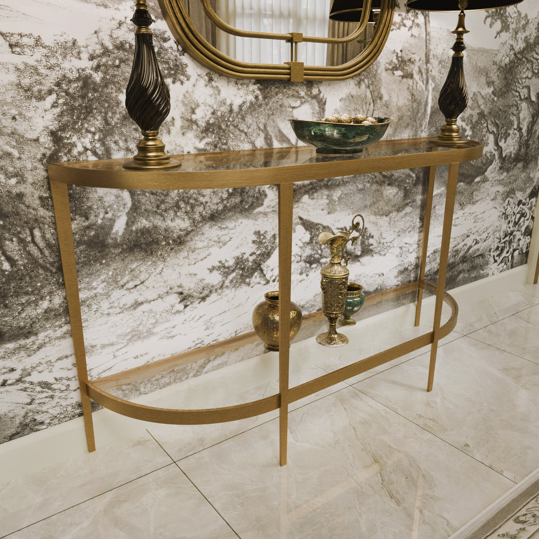 Elegant gold console styled with dark lamps, ceramics, and a scenic mural backdrop