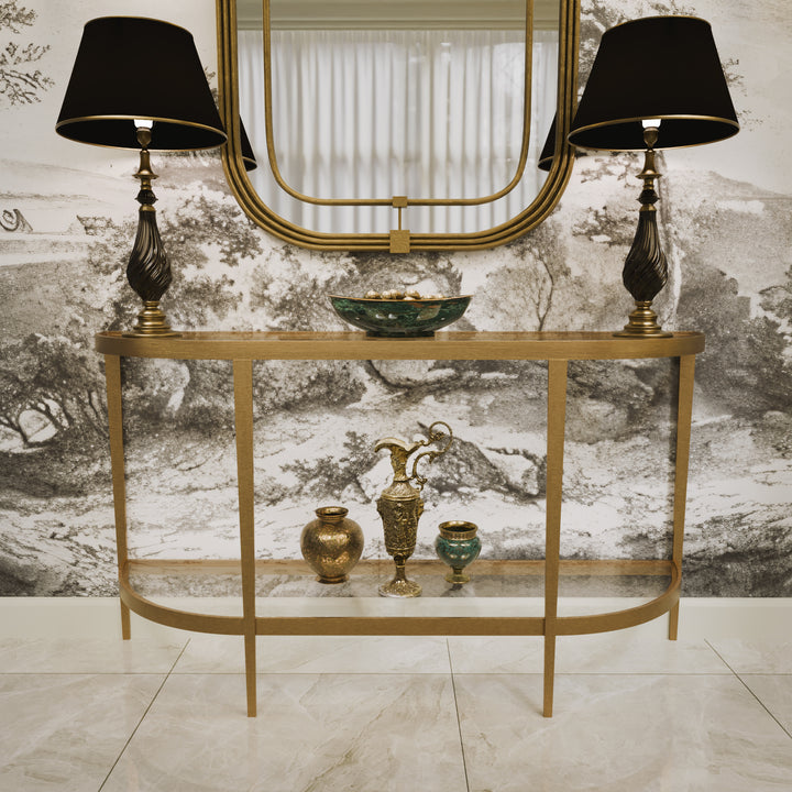 Front view of modern gold console and matching mirror styled with dark lamps, accessories and scenic wallpaper backgroud