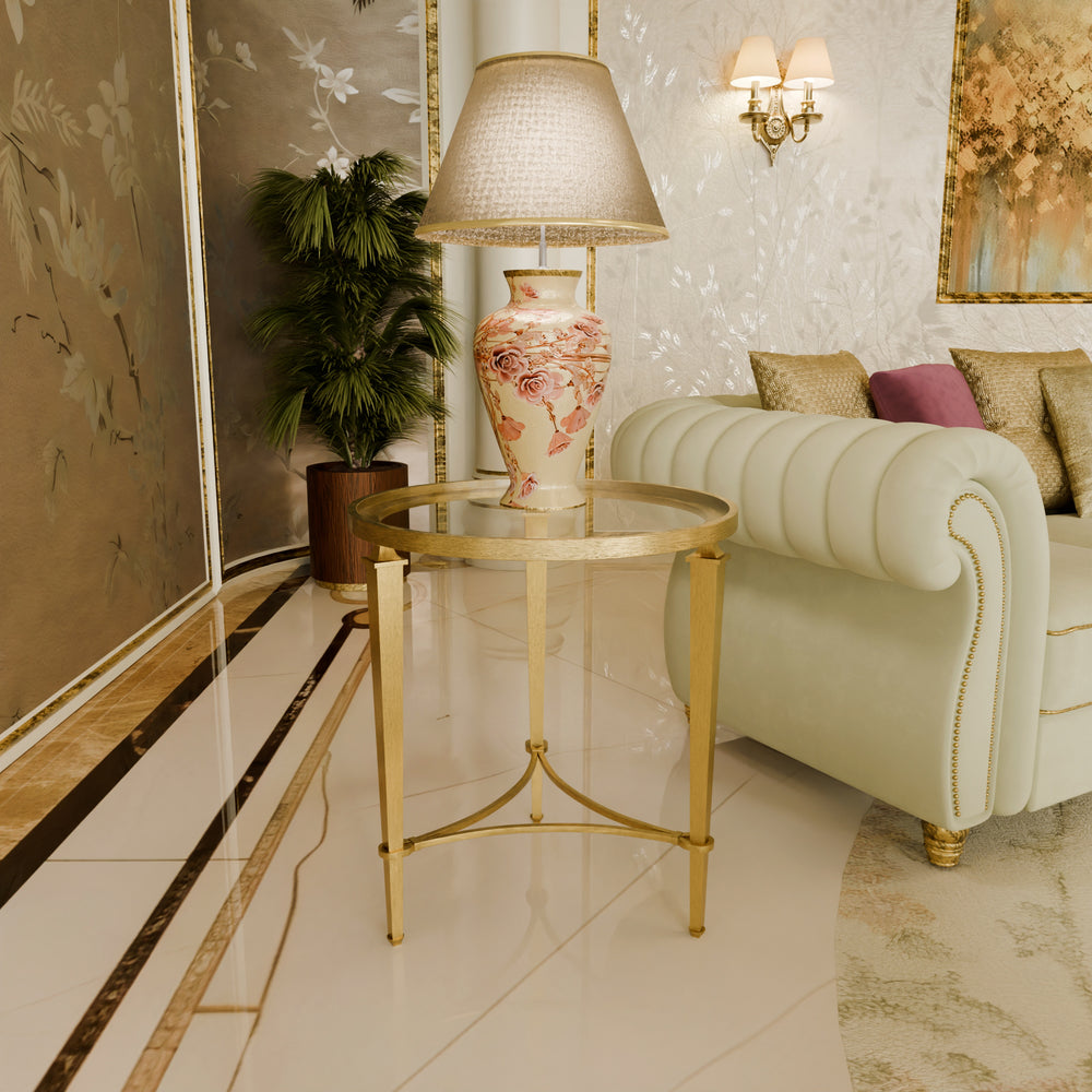 Decorative interior with a gold elegant side table, lamp, and sofa in a stylish room.