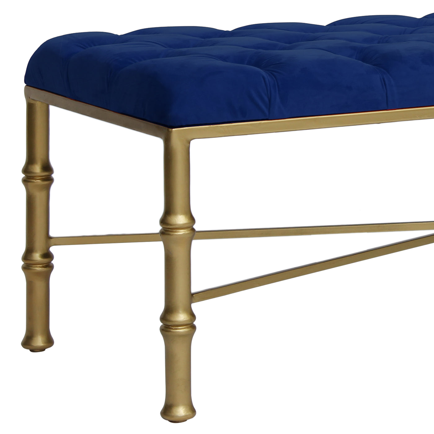 Close up of a unique metal bench with bamboo styled legs, topped with a navy blue tufted cushion