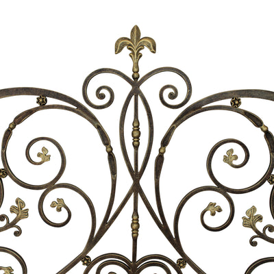 Close up of an Art Nouveau inspired hand forged headboard made up of scrolls and leaves, in an antique bronze finish