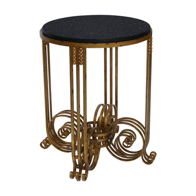 An accent table inspired by the 'Art Deco' movement which has an antique gold base and a black granite top