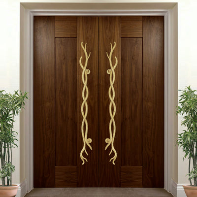 A pair of golden accent pull handles inspired by twisted branches mounted on a closed wooden door