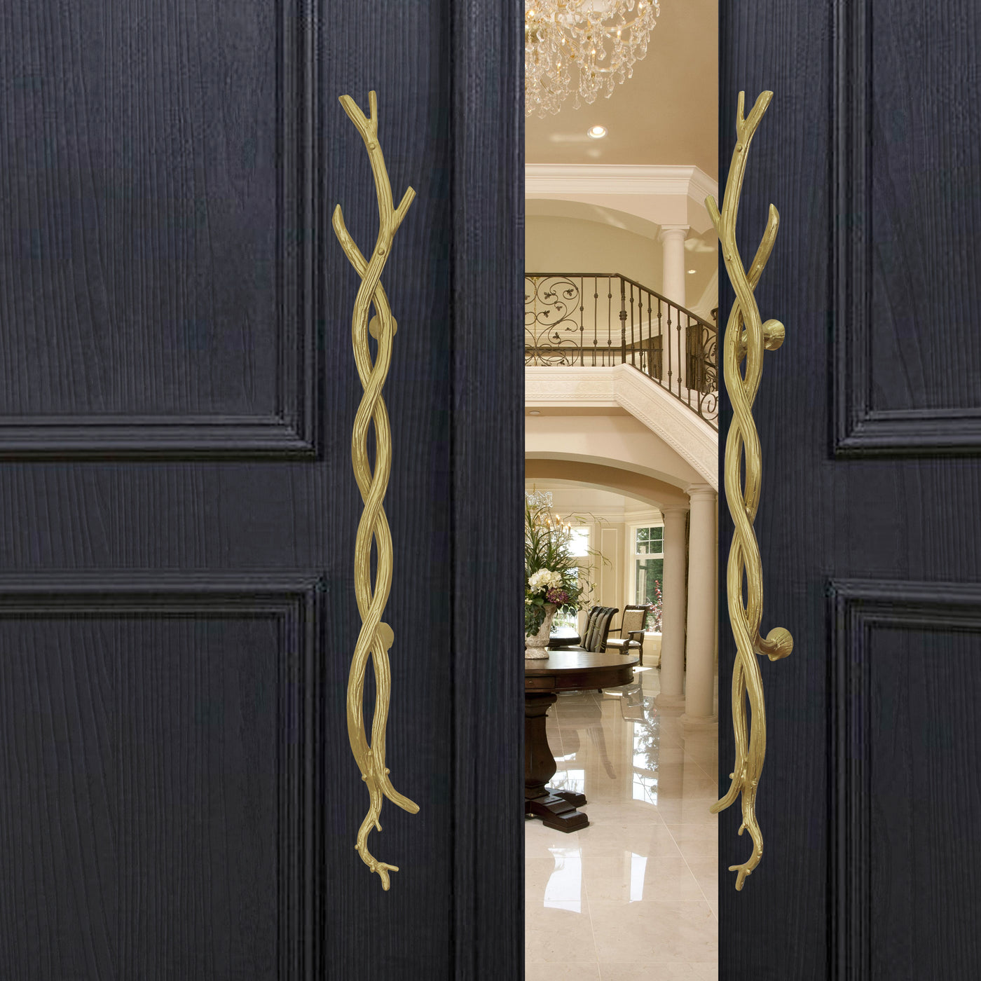 A pair of accent golden pull handles inspired by twisted branches mounted on an open wooden door