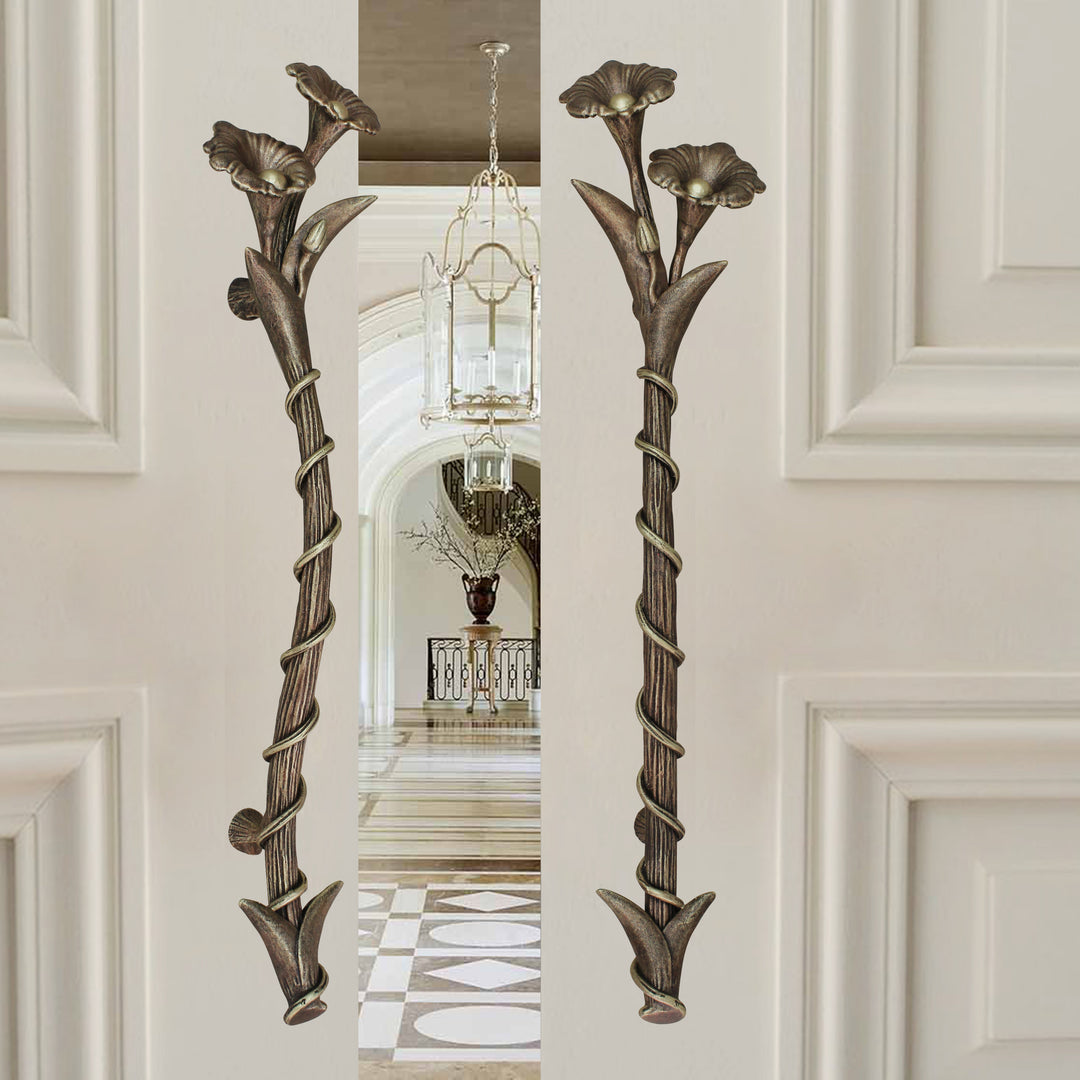 A pair of dark bronze accent pull handles inspired by flowers mounted on an opened wooden door