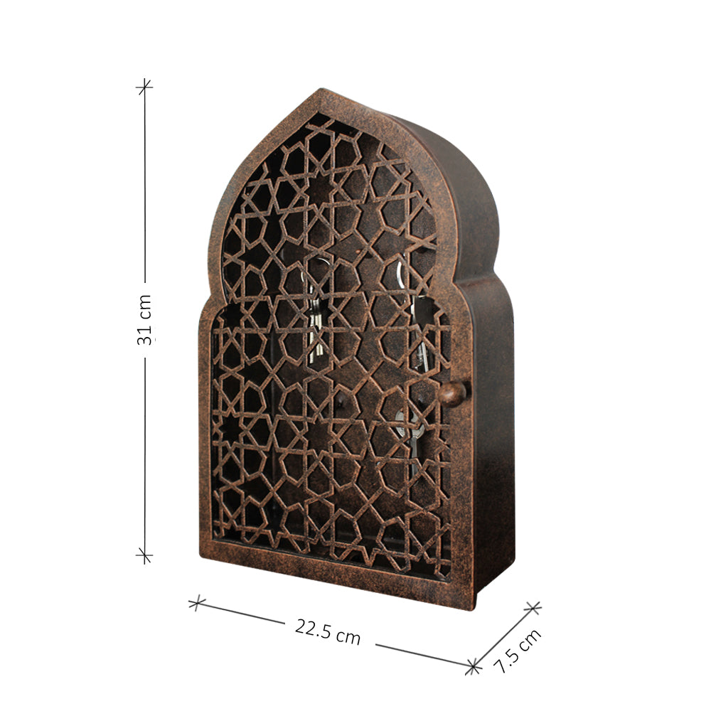 An accent key cabinet with an Islamic design pattern painted in an antique bronze finish