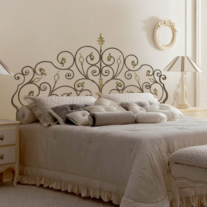 A luxurious wrought iron double bed inspired by nature; with scrolls and leaves painted in an antique bronze color