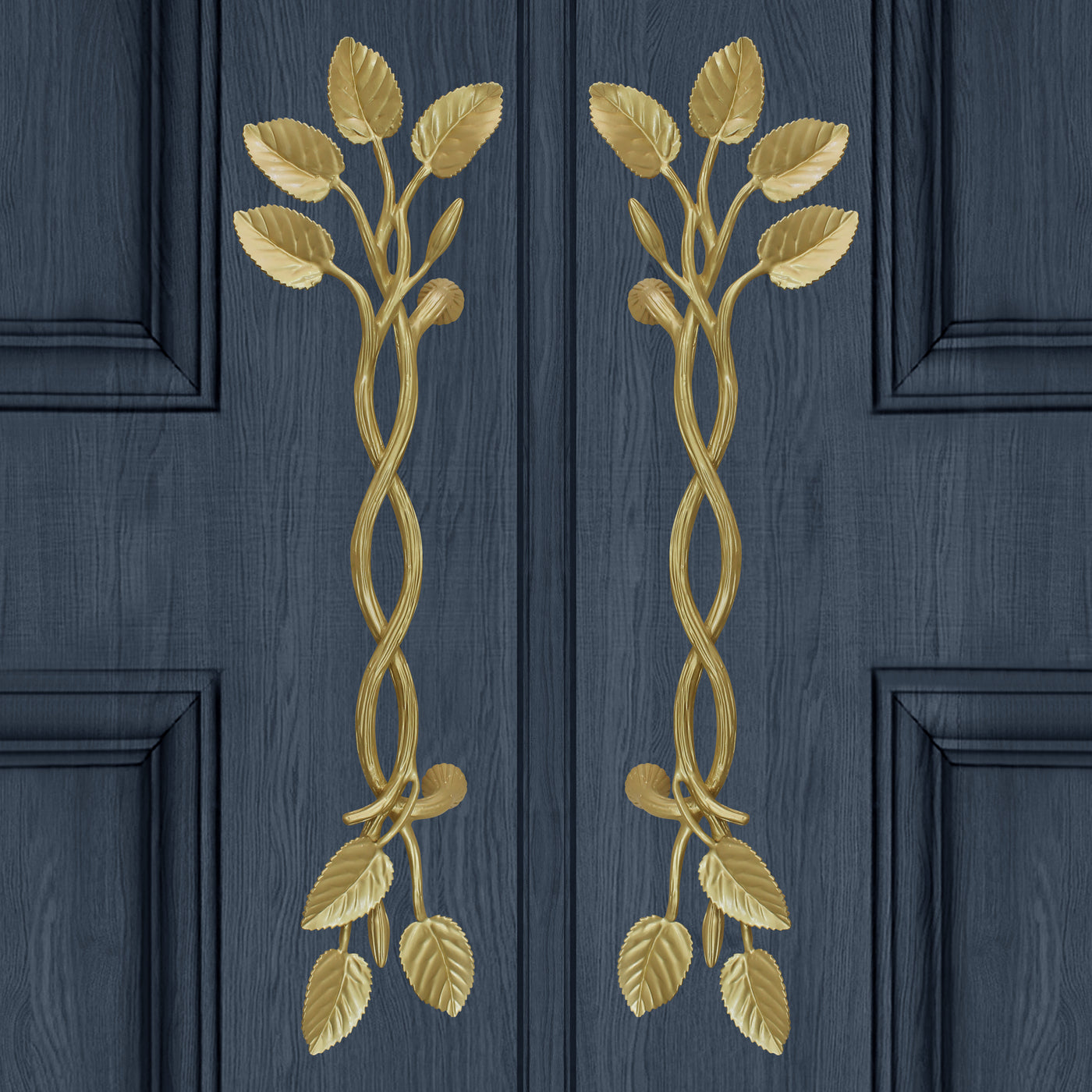 A pair of large  golden decorative pull handles inspired by branches, leaves and buds mounted on a closed wooden door