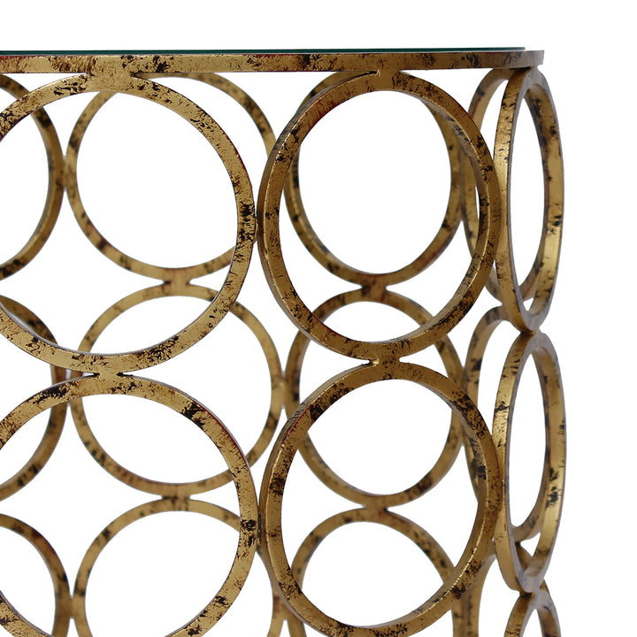 Antique gold metal rings welded side by side to create a base for a unique accent table