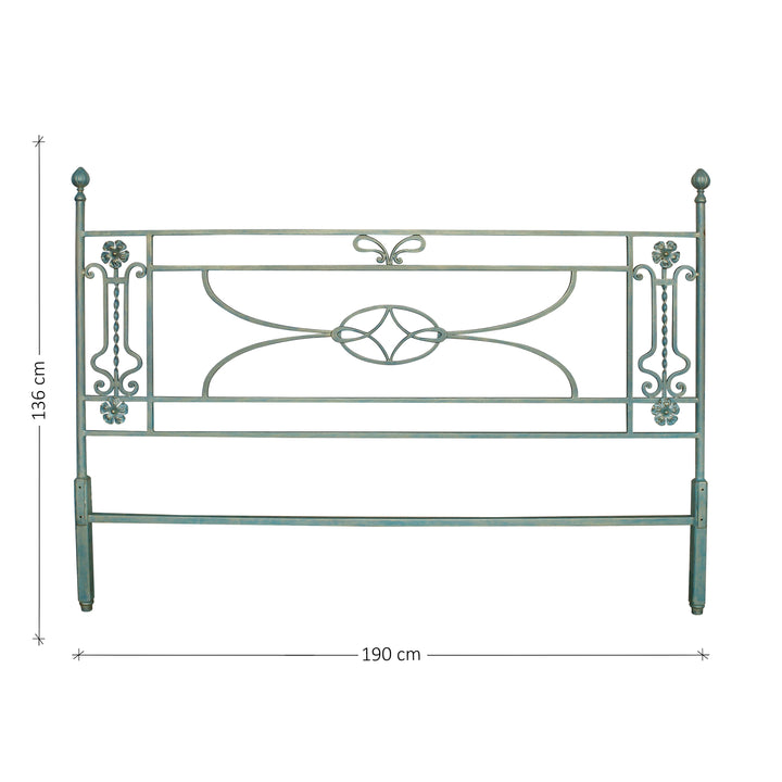 A simple classical wrought iron headboard with scrolls and flowers painted in a pastel blue color; with annotated dimensions