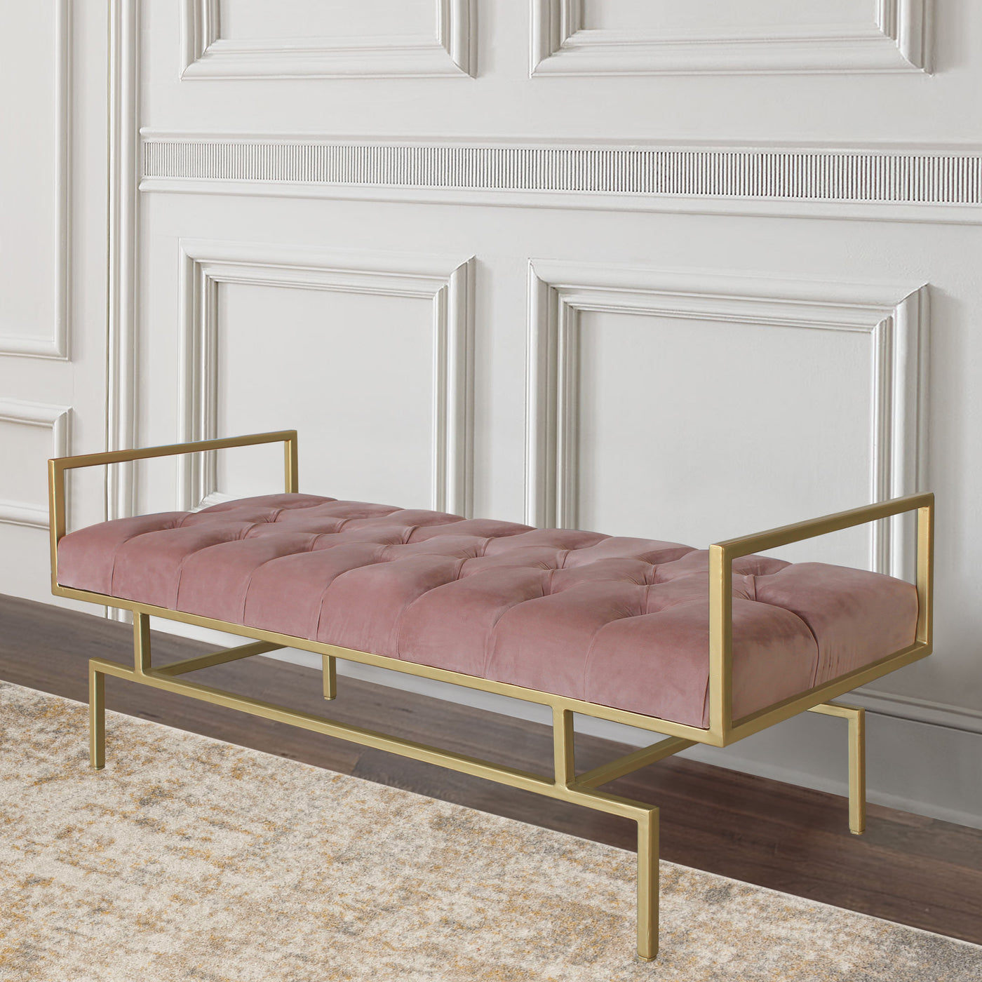 A contemporary metal golden bench topped with lilac velvet tufted upholstery in a luxurious living space