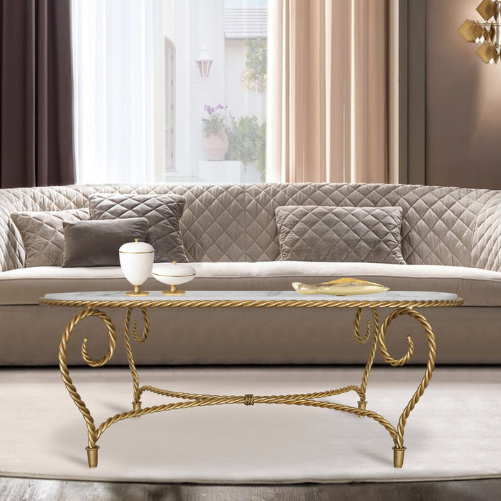 Oval-shaped coffee table inspired by twisted rope in gold color, topped white natural marble in a modern living room