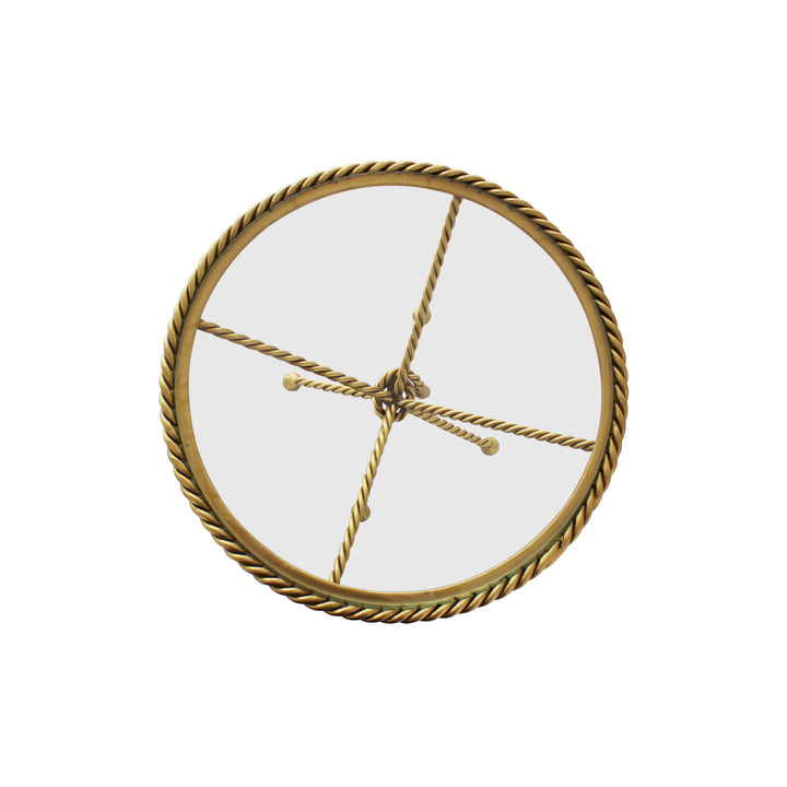 Top view of a round decorative cake plate inspired by twisted rope; topped with a clear glass