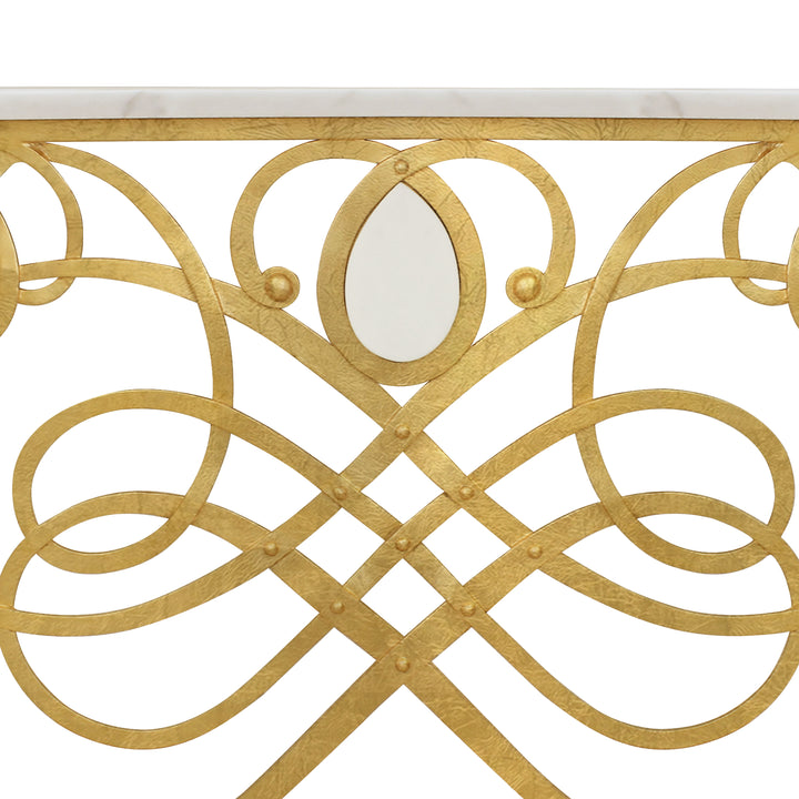 Close up of a unique wrought iron entrance table with gold leaf finish, topped with white natural marble