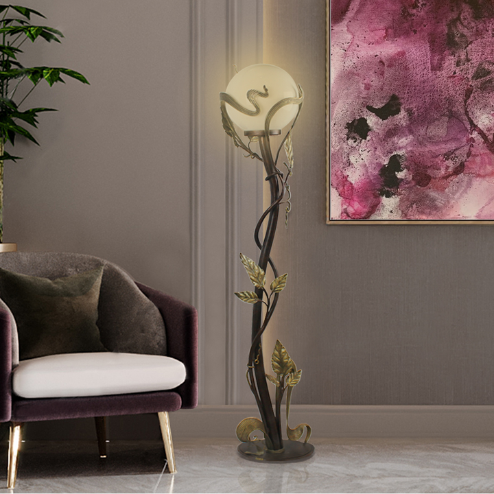 Luxurious wrought iron decorative floor lamps made up of stems and leaves, stands beside a high-end armchair