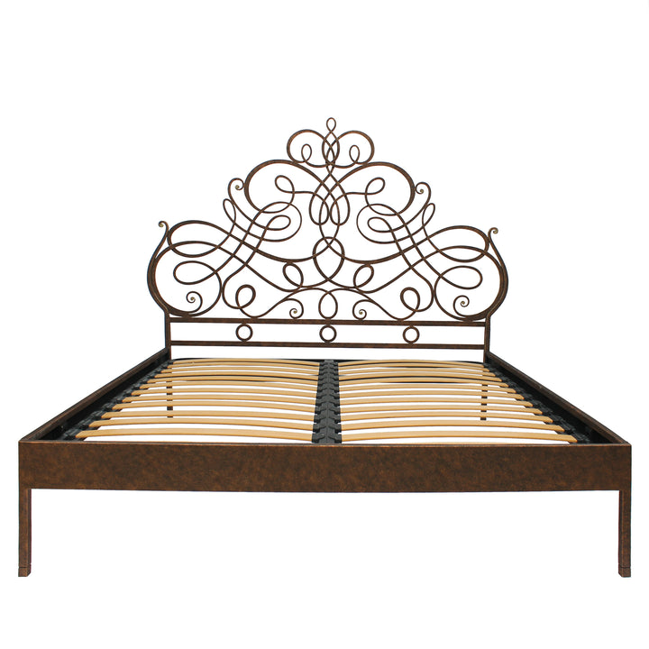A luxurious wrought iron king sized bed with an organic style painted in an antique bronze finish