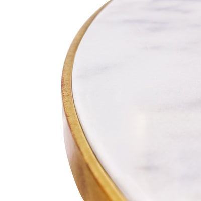 Close up of a white natural marble supported in a metal frame of a round entrance table