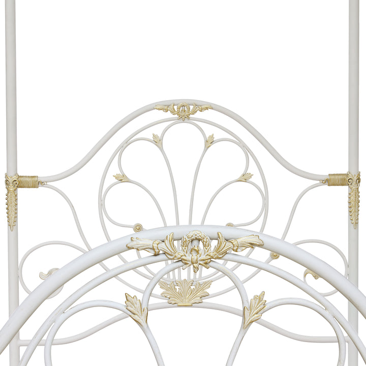 Headboard and footer of a contemporary single canopy bed made of wrought iron and painted in a white and gold finish