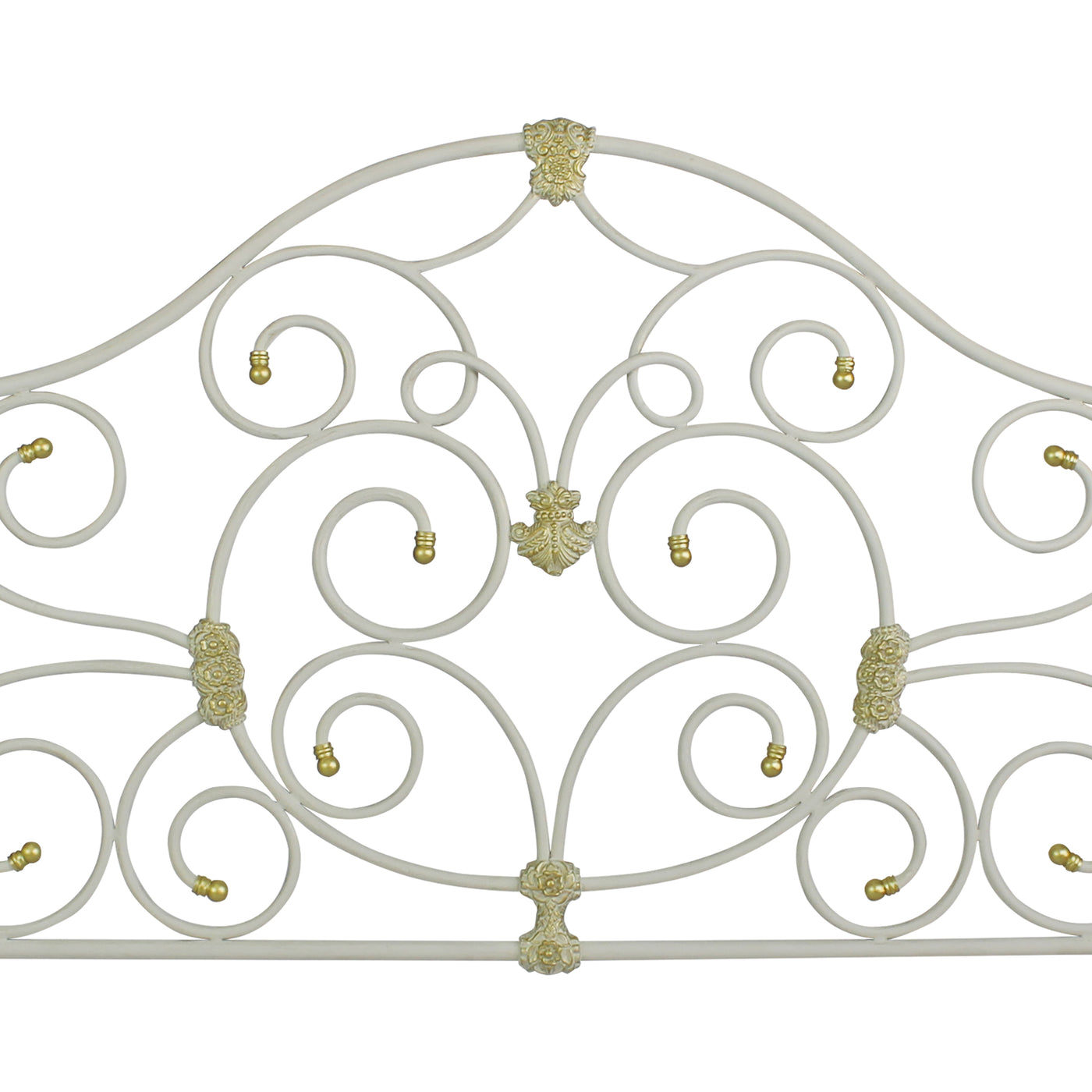 Close up of a metal headboard for a single bed with scrolls and classical motifs, painted in white and gold