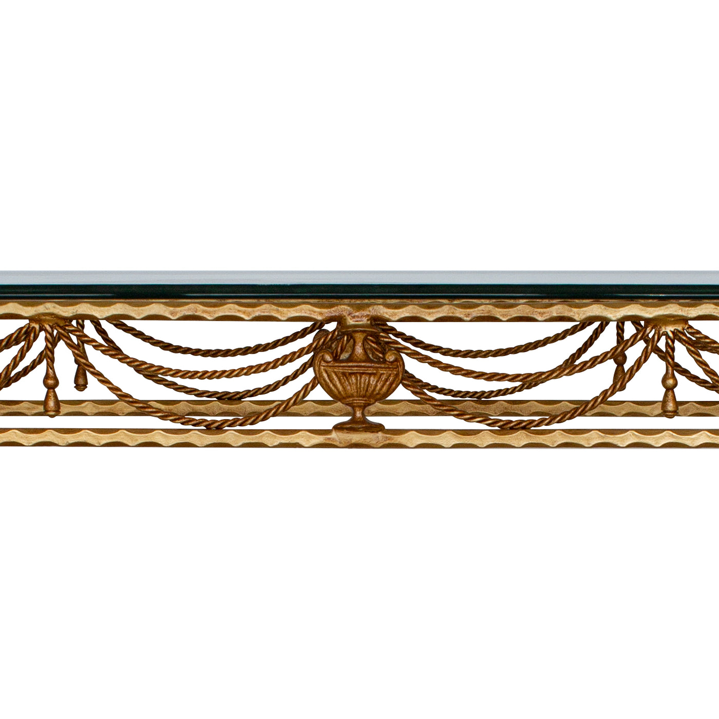 Close up of a classical wrought iron console comprised of twisted rope painted in an antique golden finish, topped with clear glass